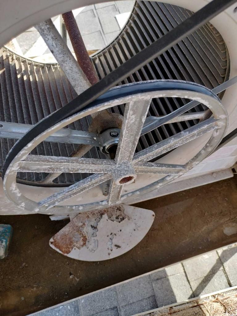 Cooling tower fan assembly with belt and pulley.