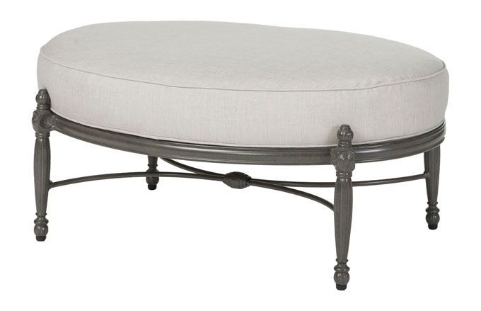 A round ottoman with a white cushion on a white background