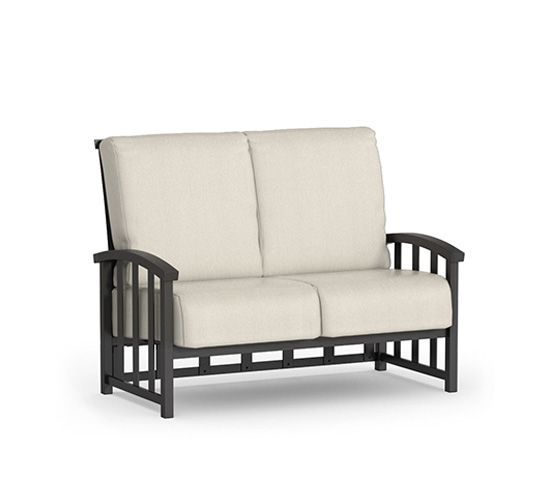 A black couch with white cushions on a white background.