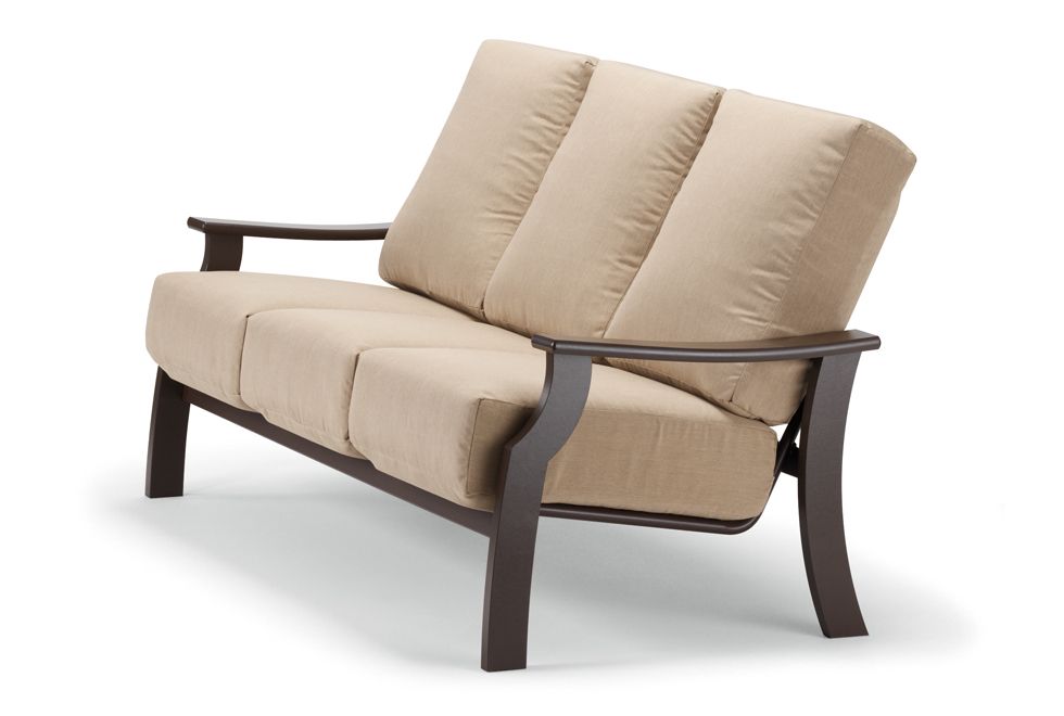 A beige couch with wooden arm rests on a white background