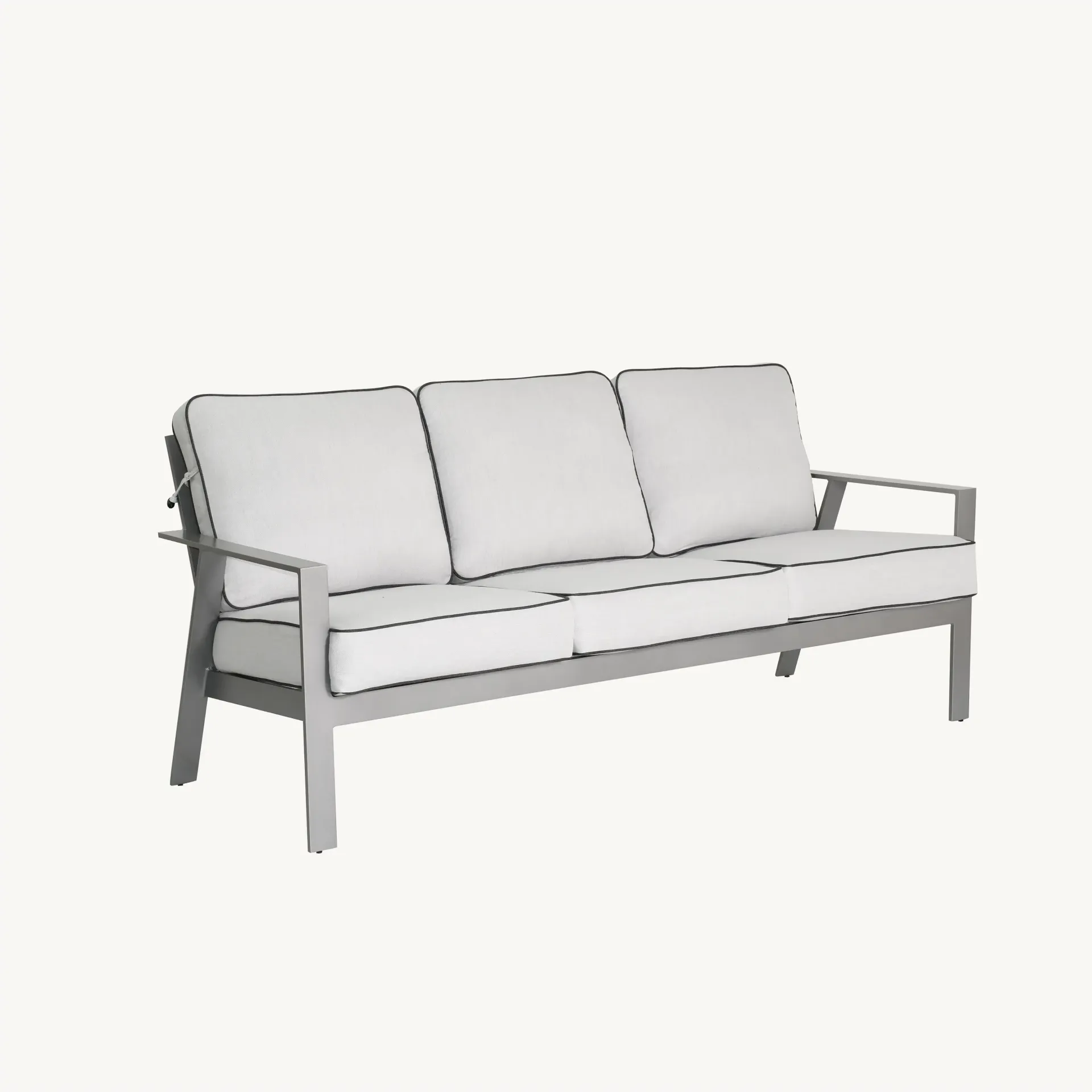 A grey couch with white cushions on a white background.