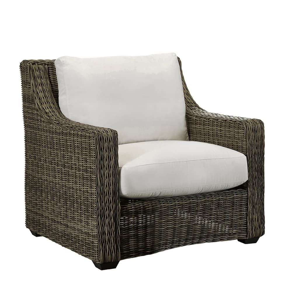 A wicker chair with a white cushion on a white background