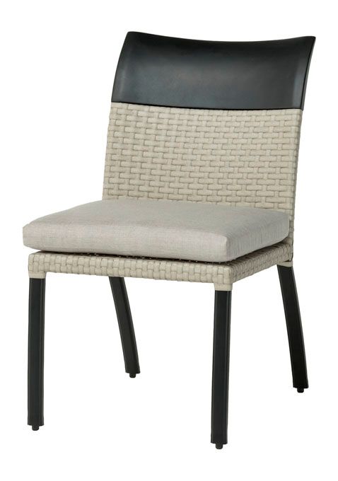 A wicker chair with black legs and a white cushion