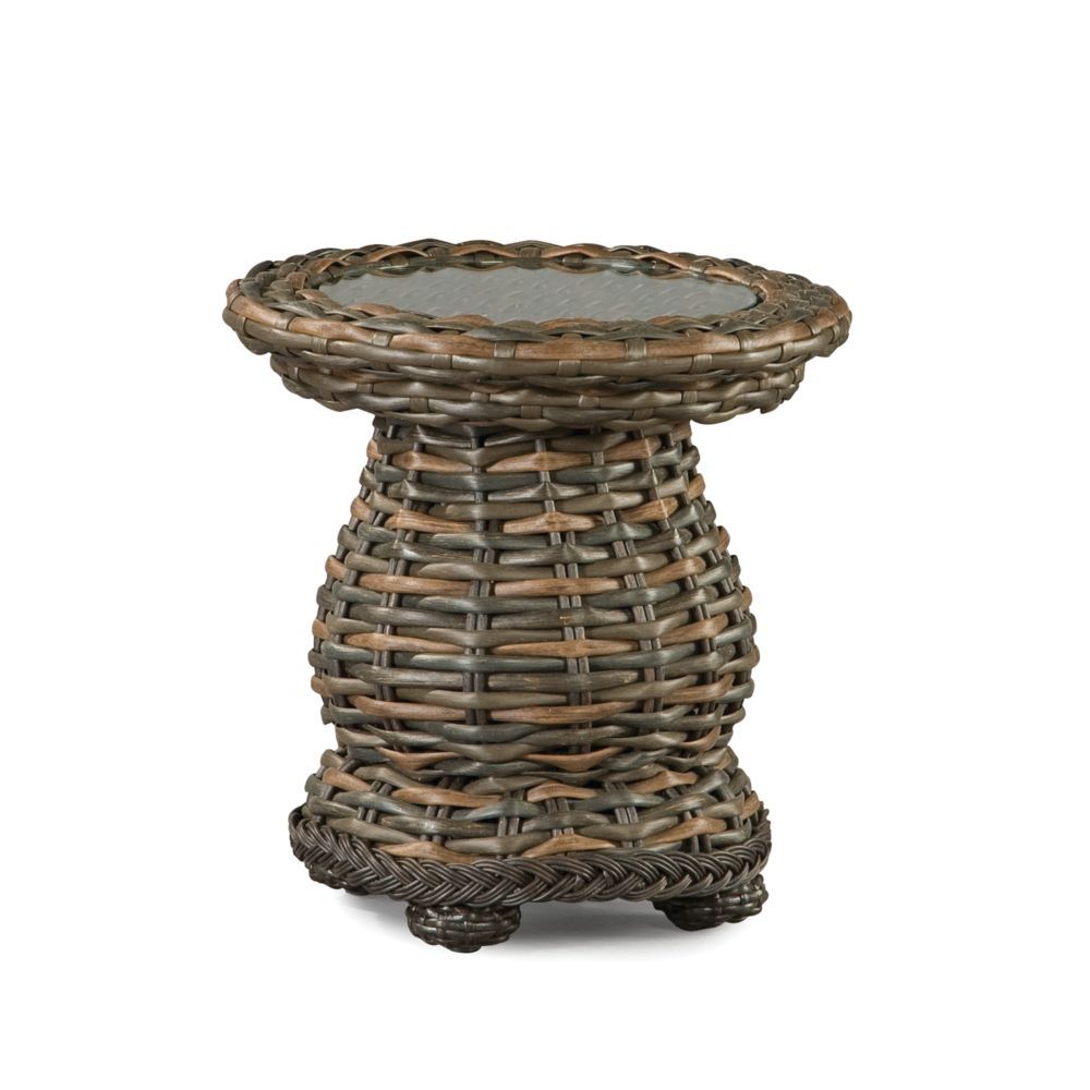 A small wicker table with a glass top on a white background