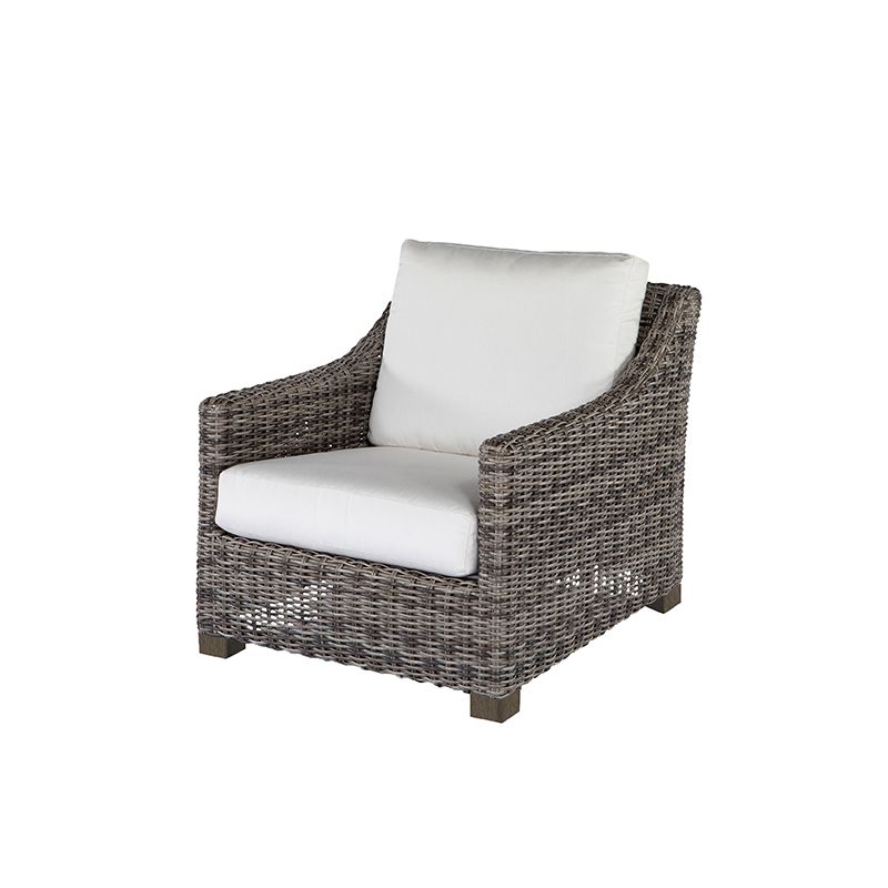 A wicker chair with a white cushion on a white background