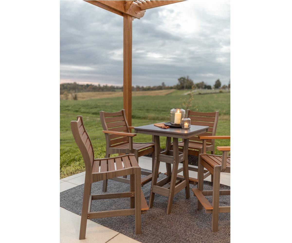 A table and chairs are sitting under a pergola on a patio.