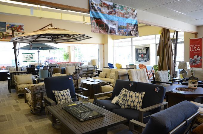 A store filled with lots of furniture and umbrellas.