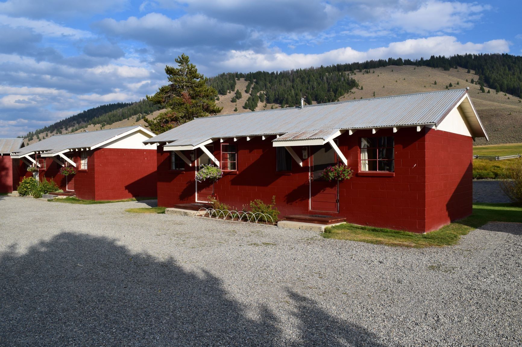 A row of red houses with mountains in the background