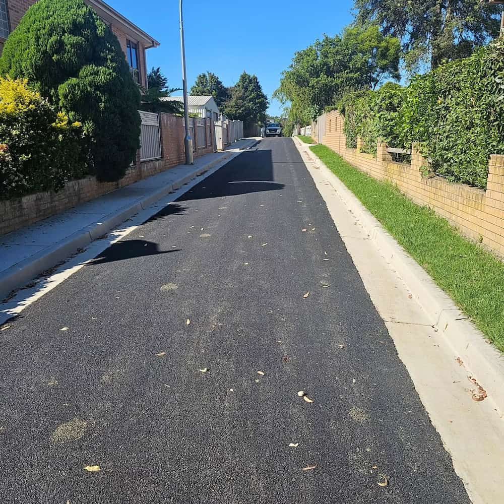 Newly Paved Asphalt Road With Concrete Curbs — Dirt Werx in Nowra, NSW