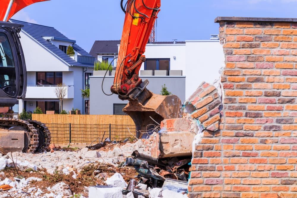 An Excavator Demolishes a Brick Wall, Debris Scattered — Dirt Werx in Merimbula, NSW