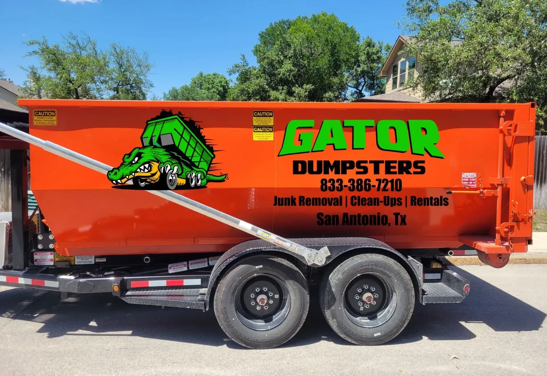 An aerial view of a dump truck driving down a road next to a body of water.