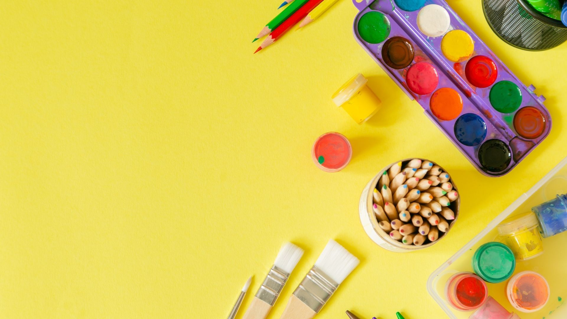 there are many different types of paints and brushes on a yellow background .