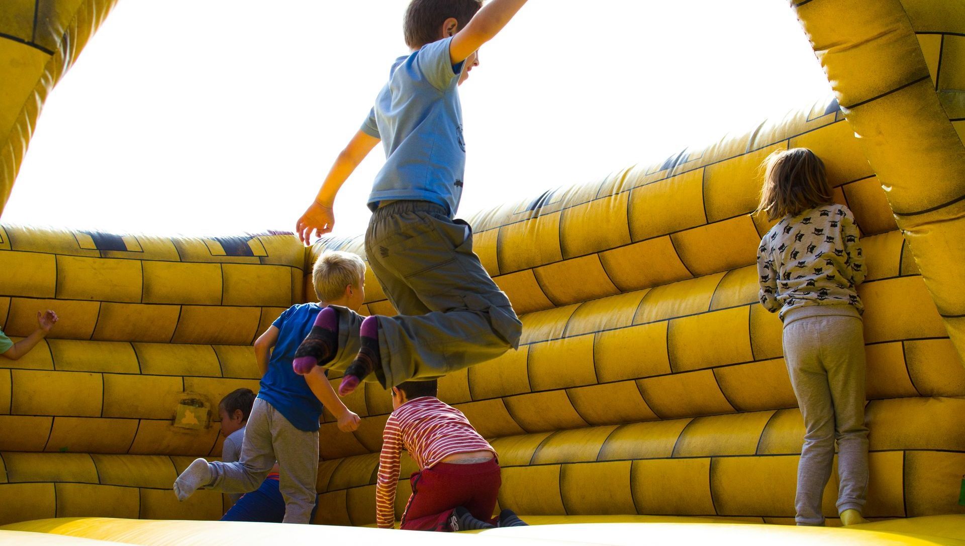 A group of children are jumping in a bouncy house