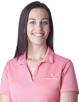 Woman with dark hair smiling, wearing a pink polo shirt with a logo.