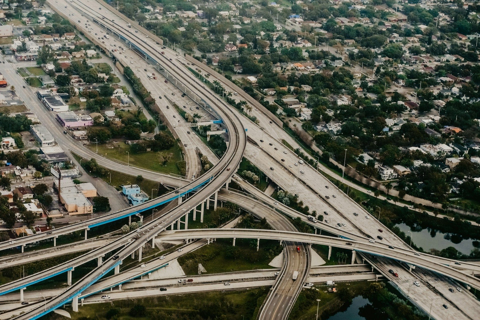 Overhead view of a multi-lane highway interchange with numerous ramps, bridges, and vehicles