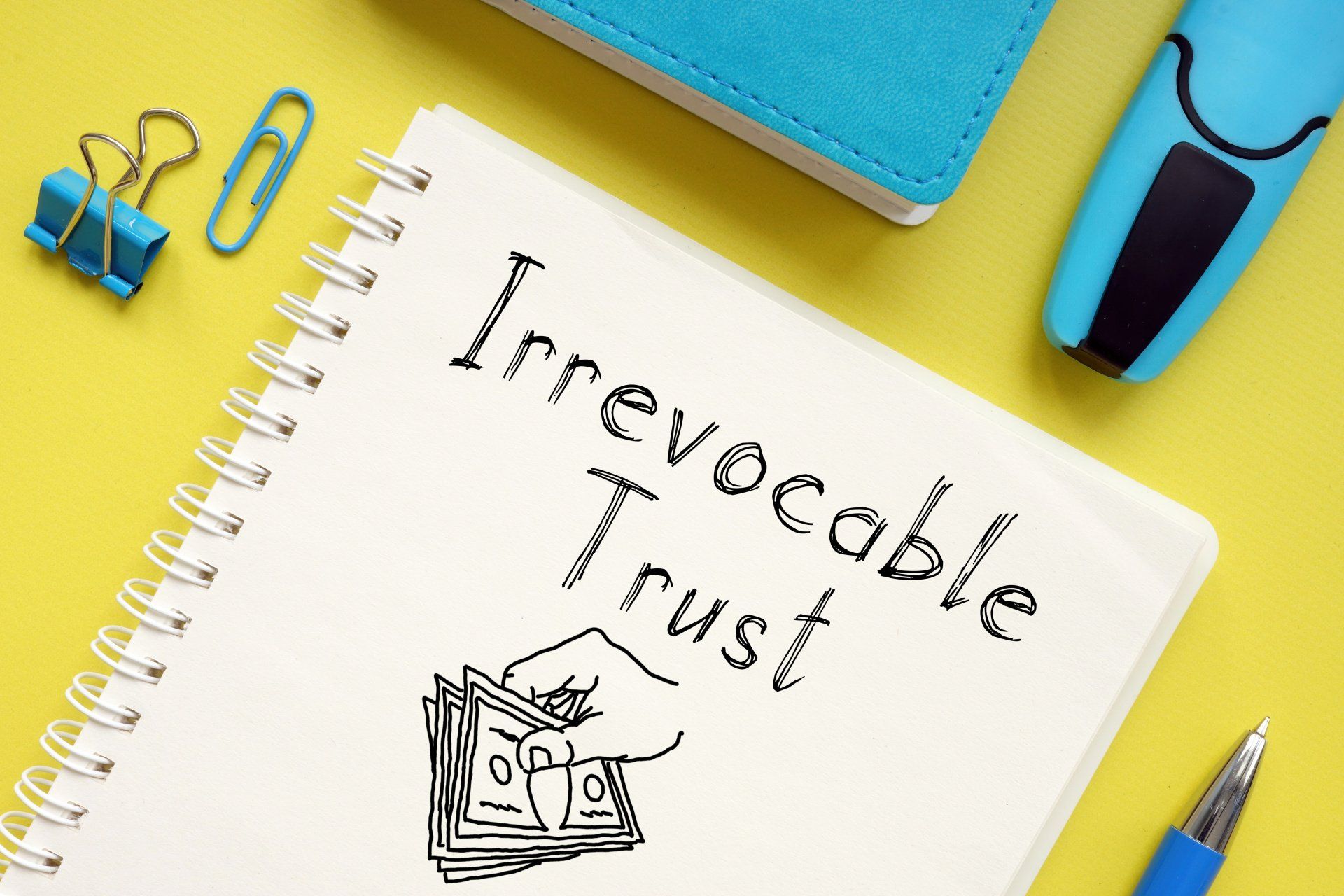 irrevocable trust on a notebook sitting on yellow desk