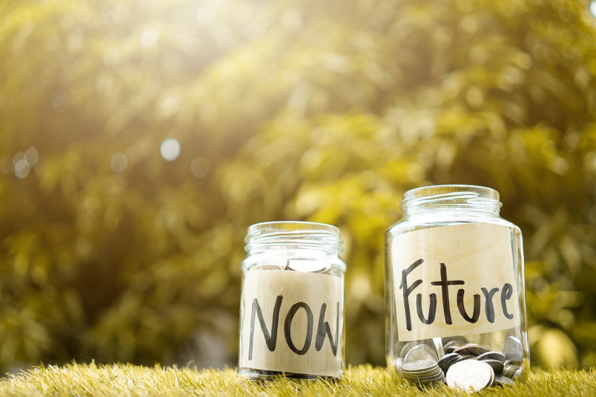 mason jars labeled as now and future for finances