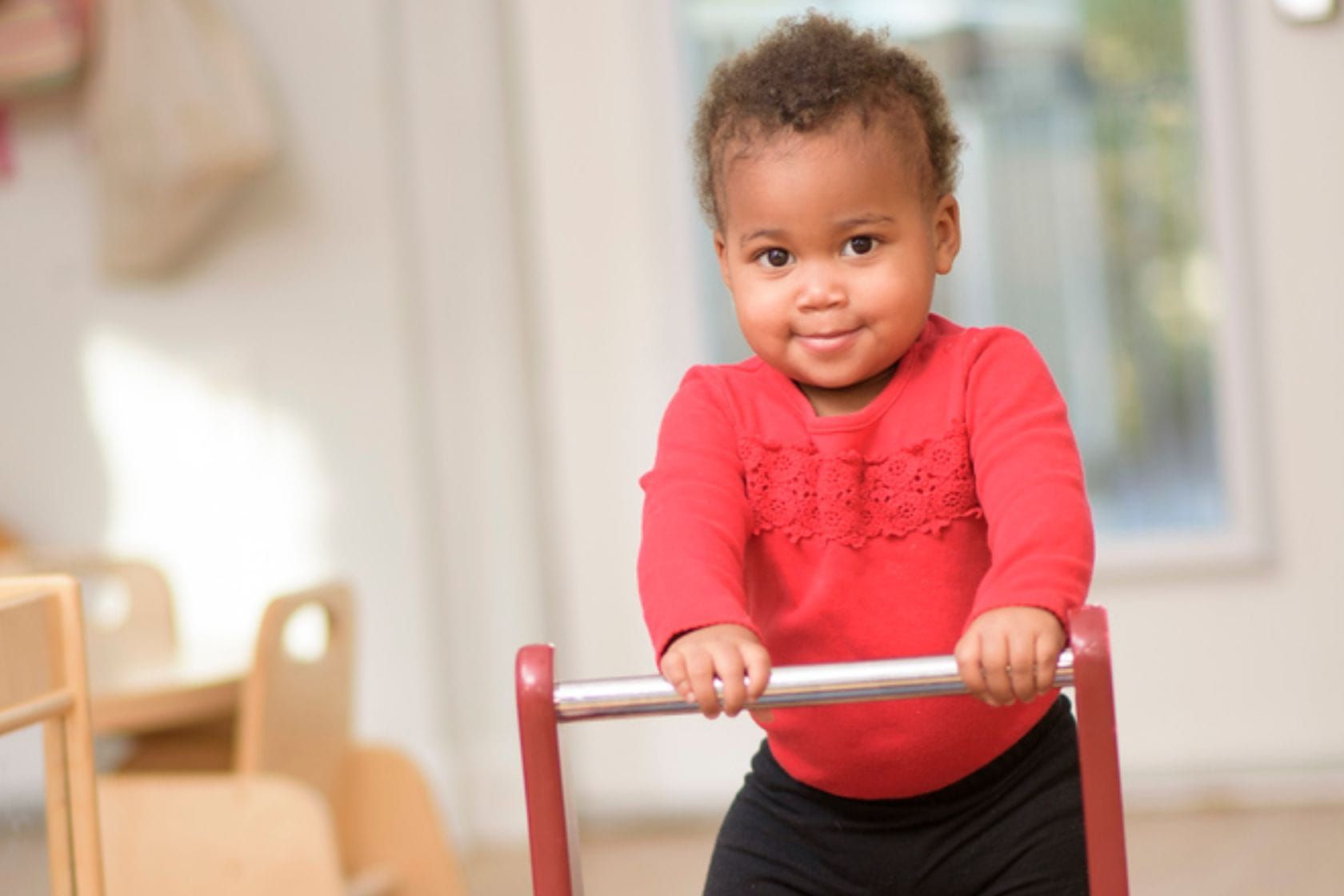 Toddler moving freely in a Montessori Classsroom. 