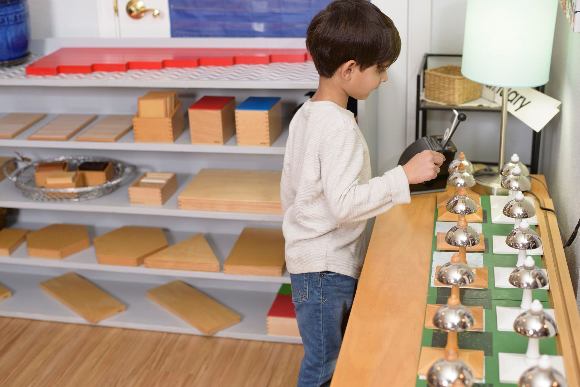 Motnessori child playing with musical instrument