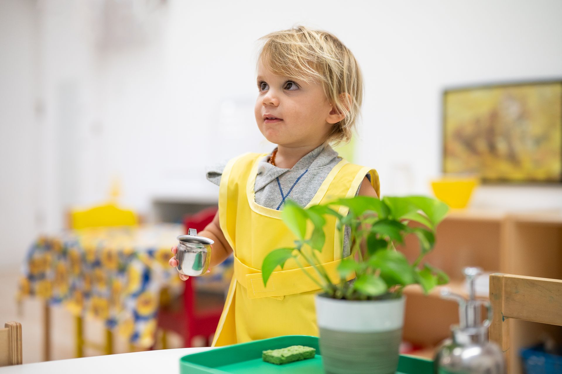 montessori child watering the plants