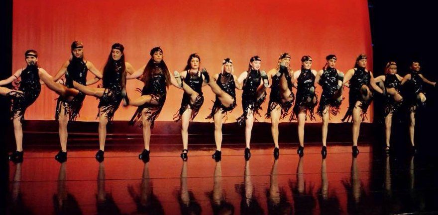 showgirl style high kick line-up on stage
