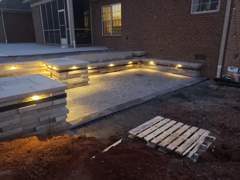 A brick house with a patio and a wooden pallet in front of it.