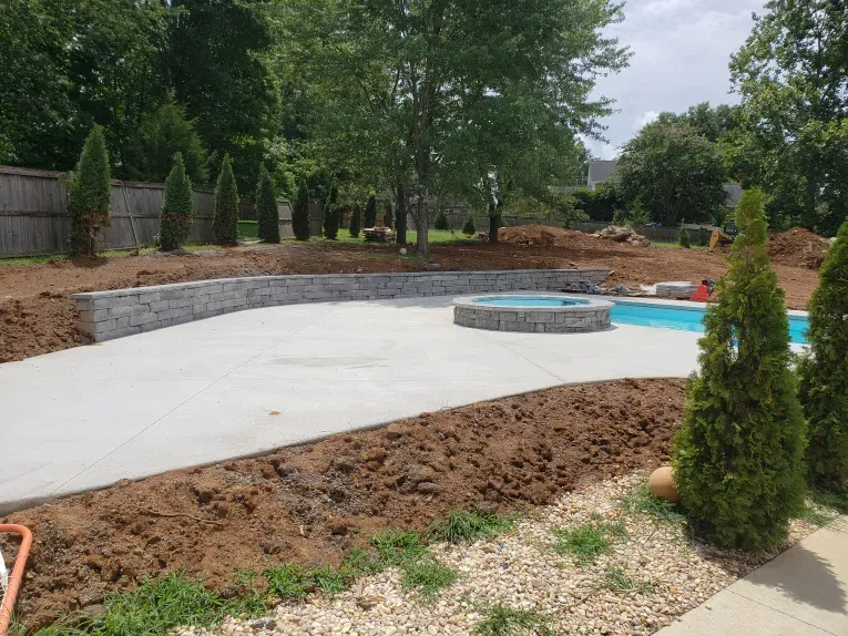 A swimming pool is being built in the backyard of a house.