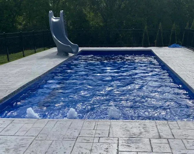 A swimming pool with a slide on the side of it