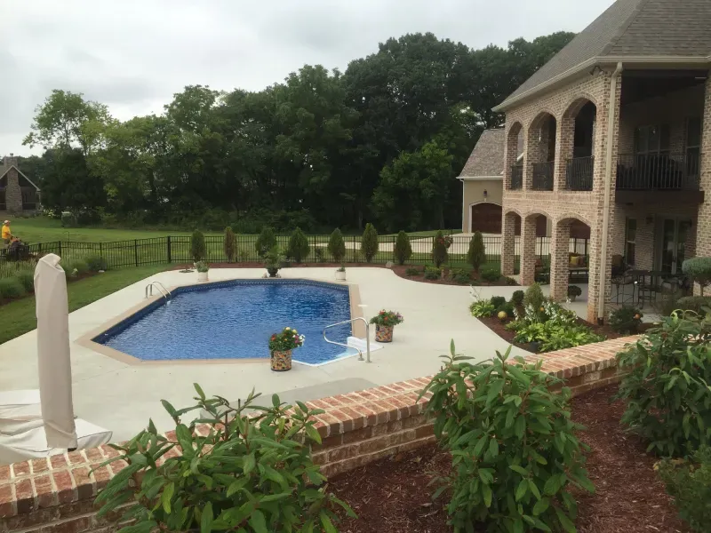 A large house with a large swimming pool in front of it