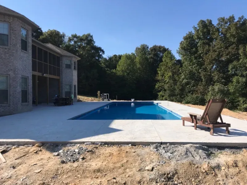 A large swimming pool in the backyard of a house