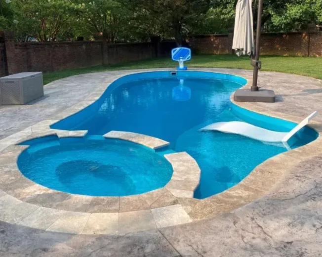 A large swimming pool with a basketball hoop in the background