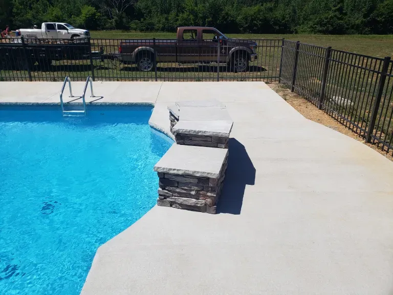 A truck is parked next to a swimming pool.