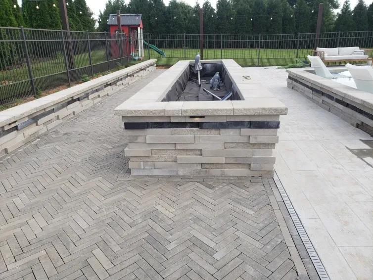 A fire pit in the middle of a brick patio