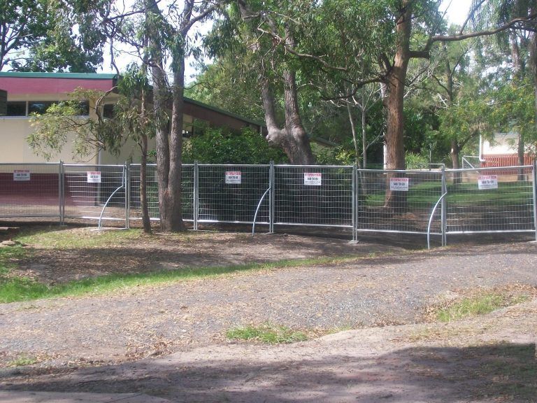 A fence with a sign on it that says no entry