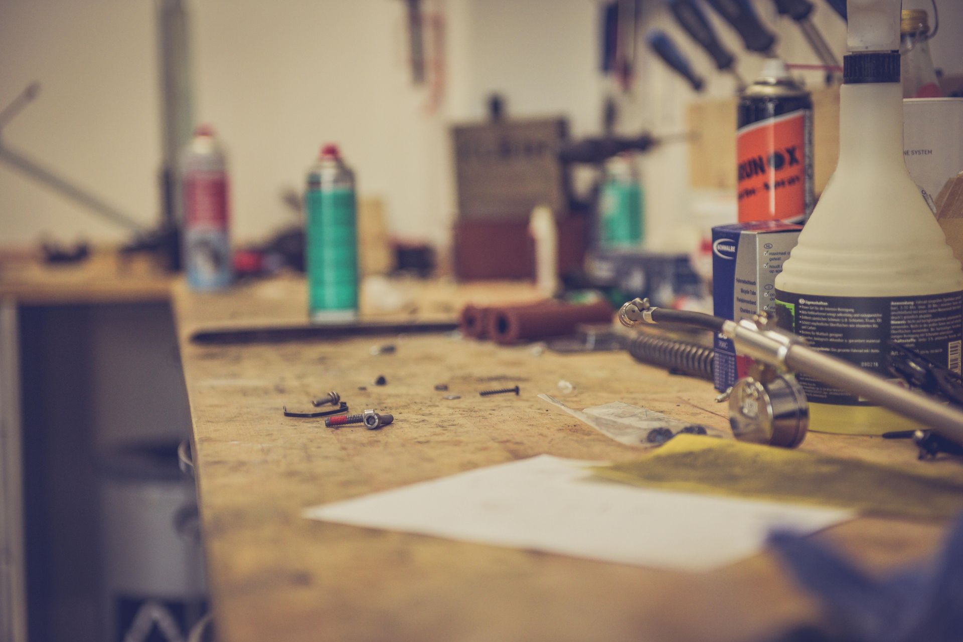 A wooden workbench with a lot of tools on it.