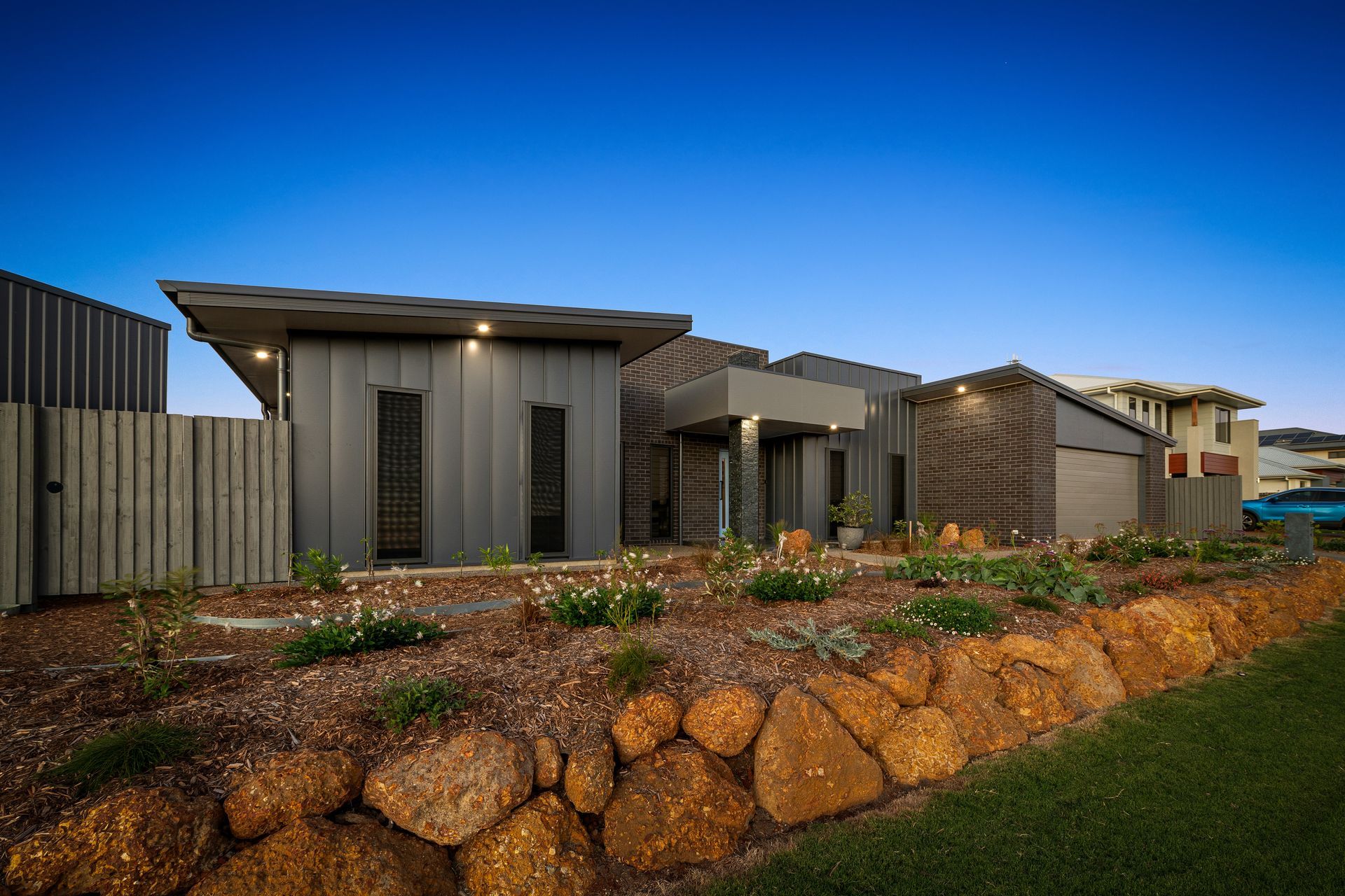 Modern Single-Story Houses at Dusk with A Stone Retaining Wall — Gatley Building Design in Woodgate, QLD