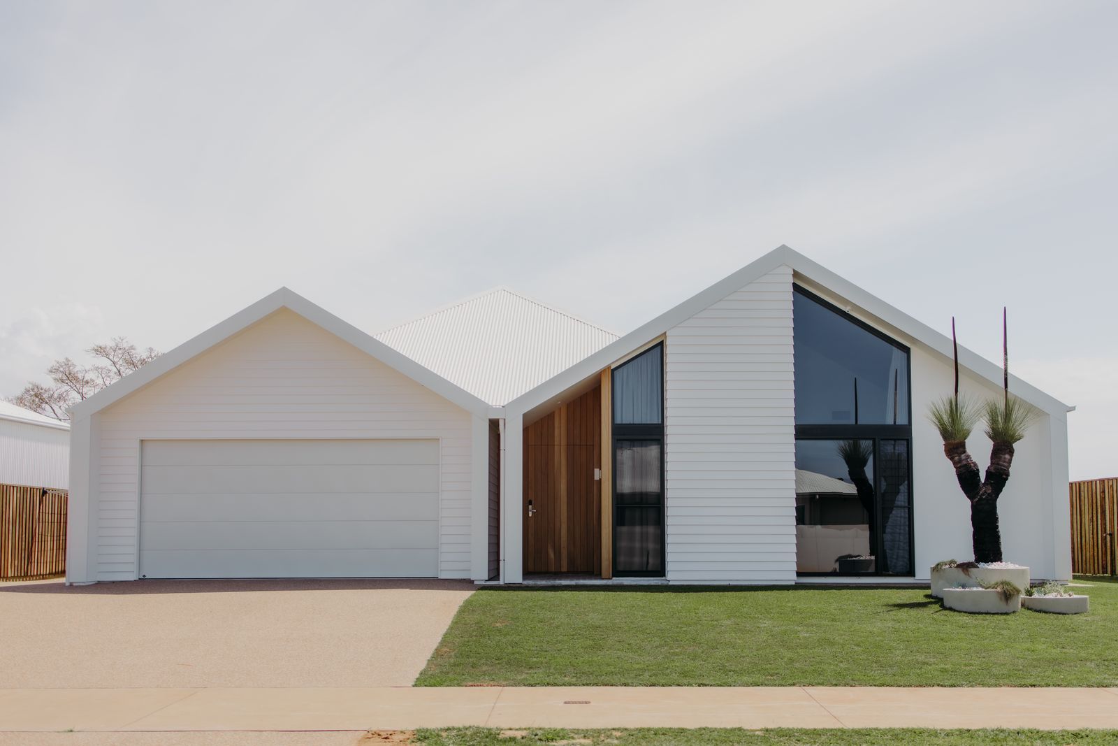 Modern White House with Garage, Large Dark Window — Gatley Building Design in Woodgate, QLD
