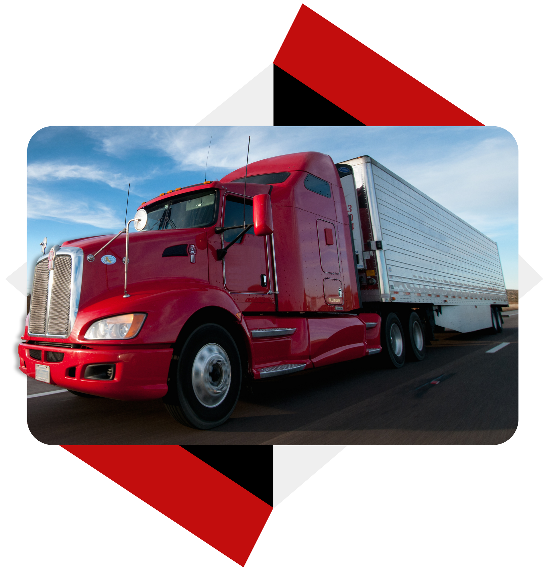 A red semi truck is parked on the side of the road.