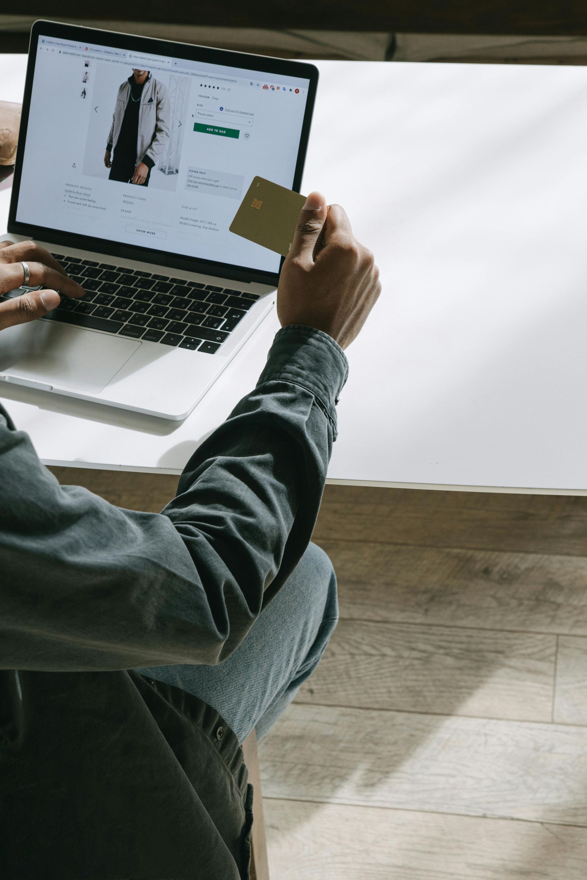 A technician in a plaid shirt installs an air conditioner with a drill while wearing safety glasses.