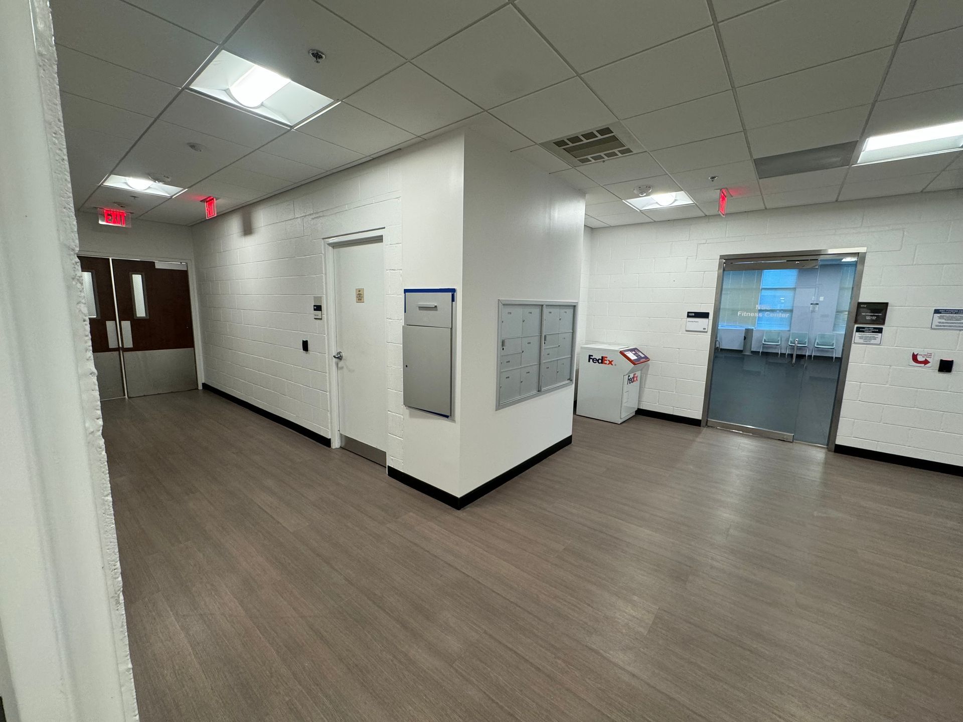 A hallway with a sign that says ' exit ' on it