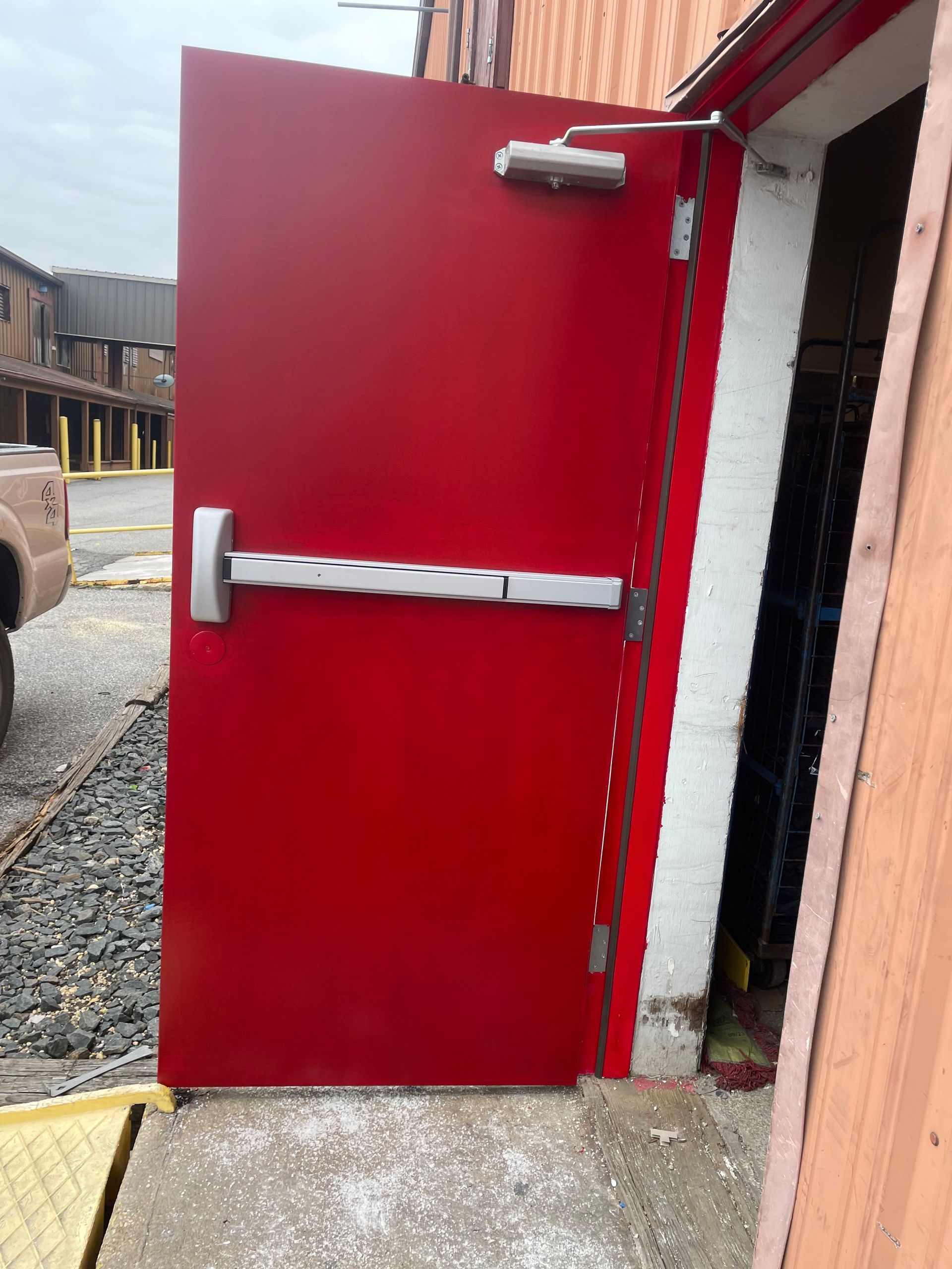 A red door with a white handle is open