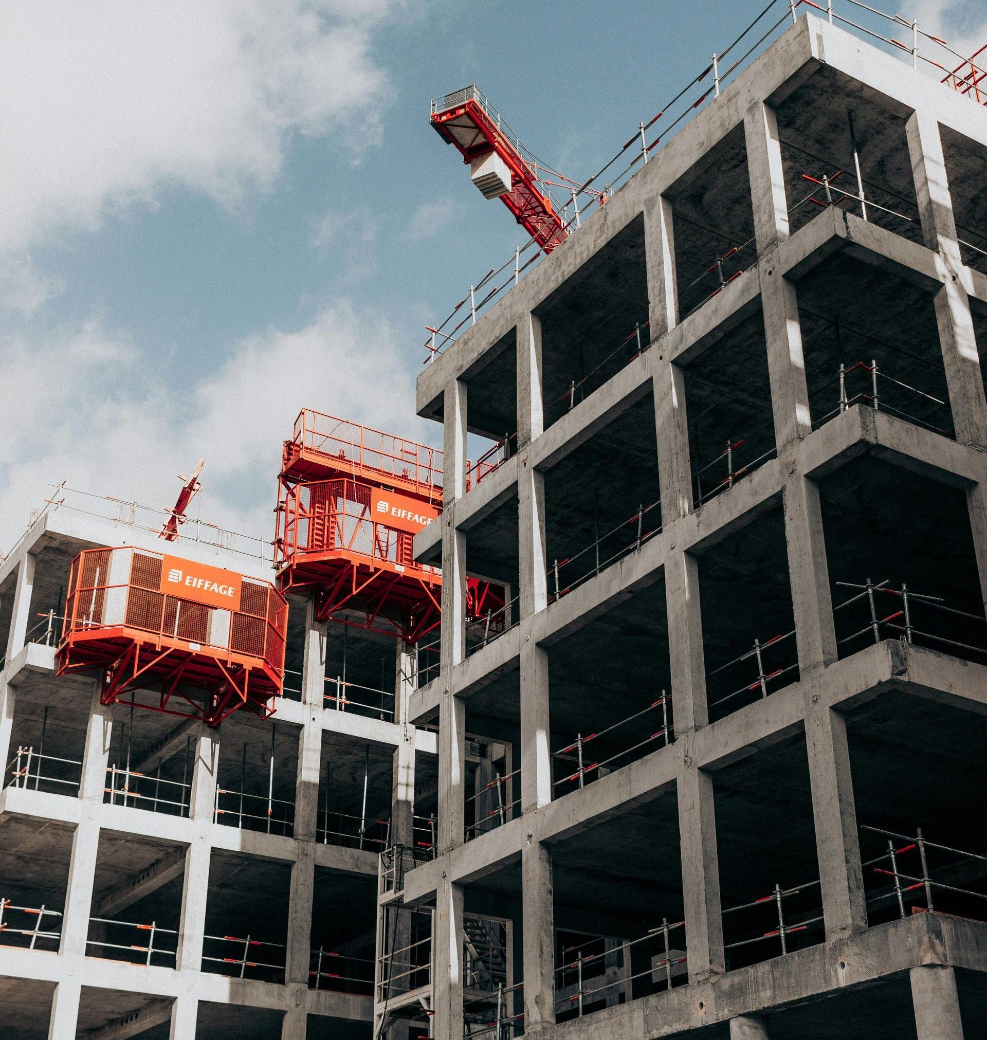 A large building under construction with a crane on top of it.