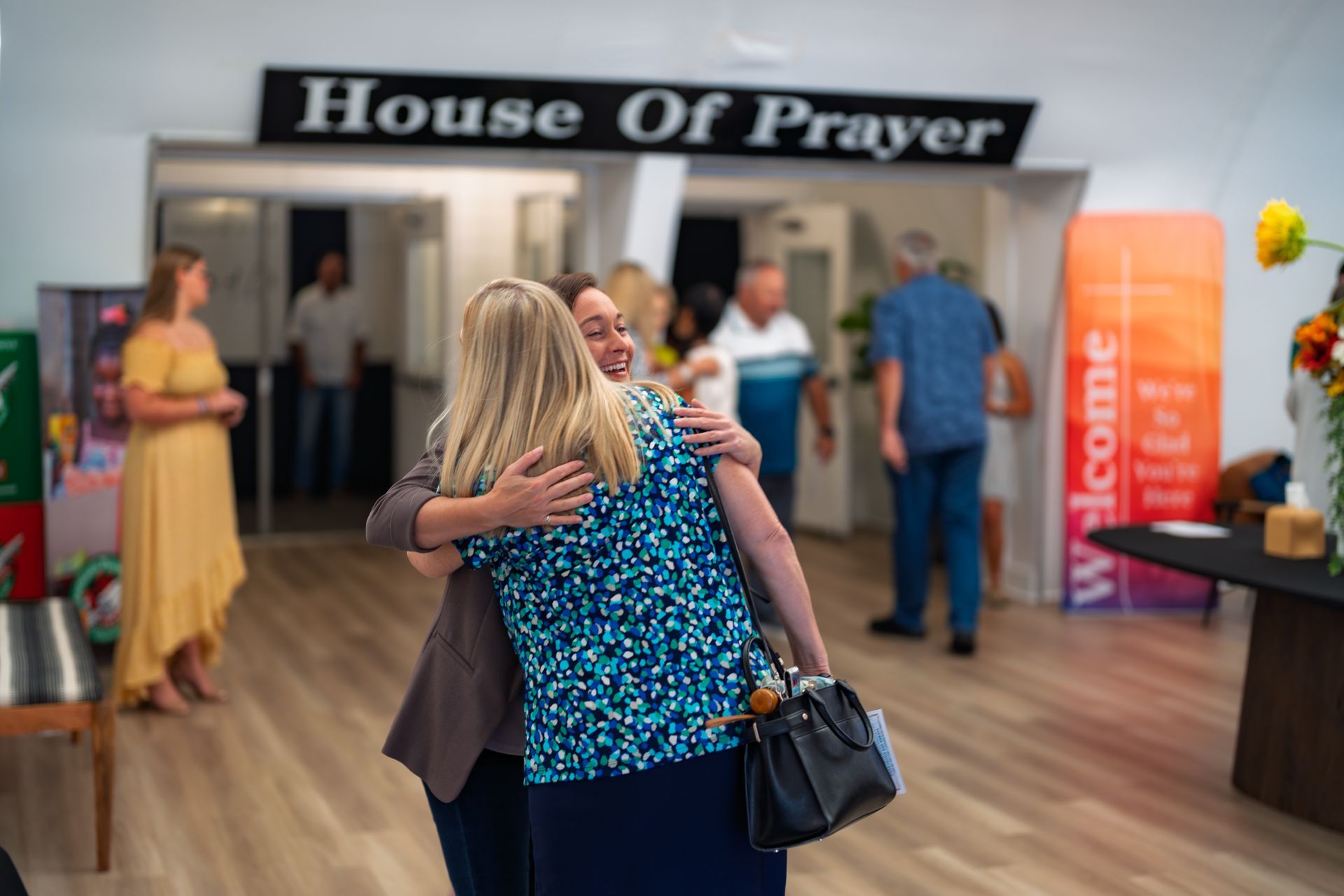 A large group of people are sitting in a church auditorium.