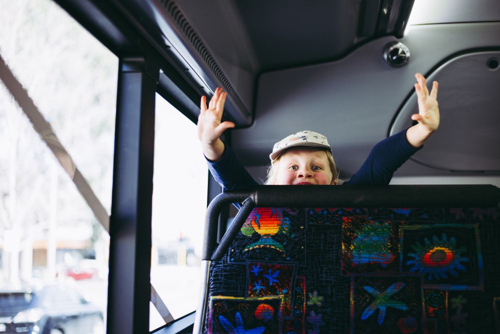 Little Girl Behind The Seat Of The Bus — TJ & B Bus and Coach Pty Ltd In South Murwillumbah, NSW