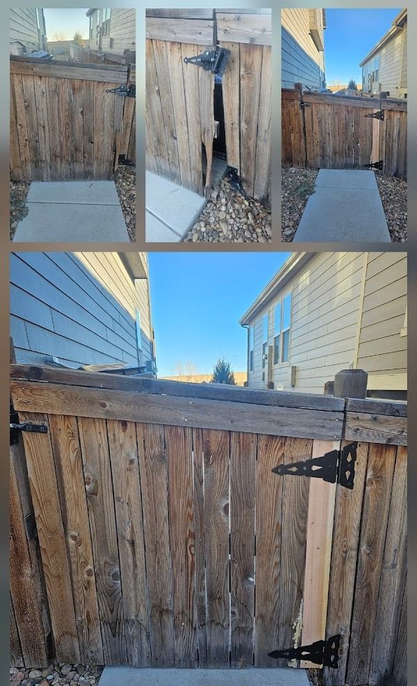 A damaged wooden fence with a walkway, and a gate. Outdoor shot with blue sky.