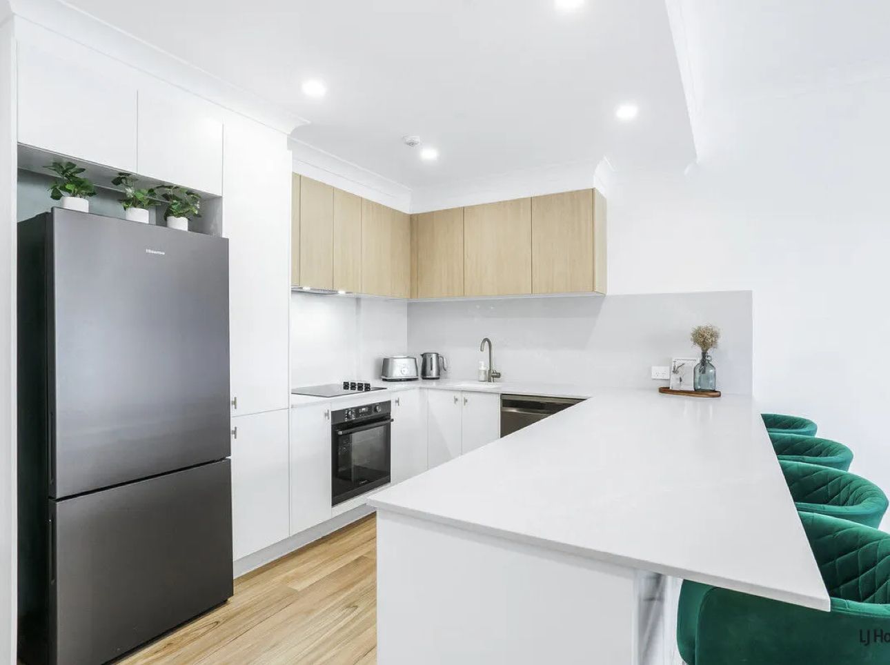 Modern Kitchen With Light Wood Cabinets, White Countertops, and Green Velvet Bar Stools — Zero 21 Fit-Outs & Joinery: Kitchen Renovation Gold Coast in Molendinar, QLD