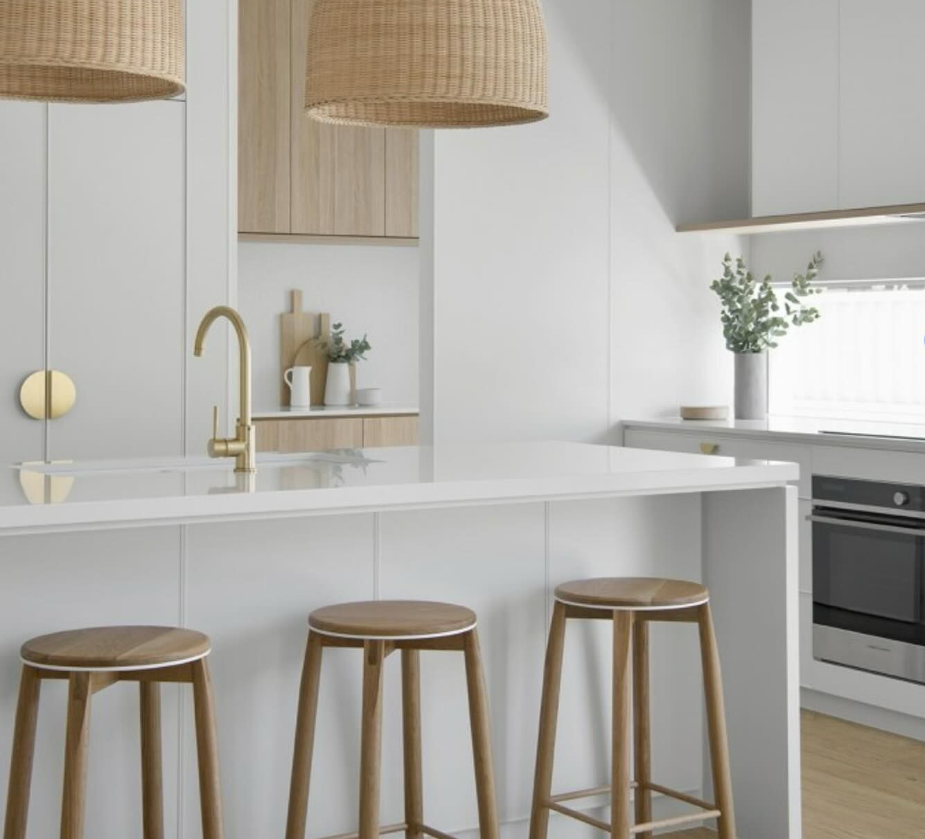 Modern Kitchen With White Cabinets, Wooden Stools, Gold Accents — Zero 21 Fit-Outs & Joinery: Kitchen Renovation Gold Coast in Molendinar, QLD