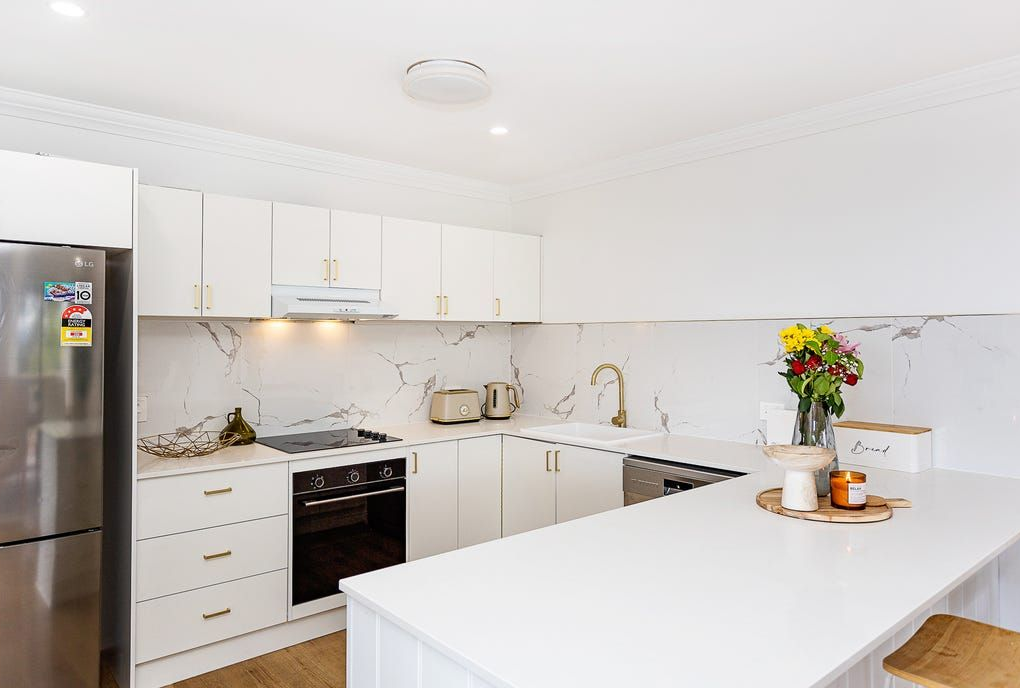 White Modern Kitchen With Stainless Steel Appliances, Countertop, and Island — Zero 21 Fit-Outs & Joinery: Kitchen Renovation Gold Coast in Molendinar, QLD