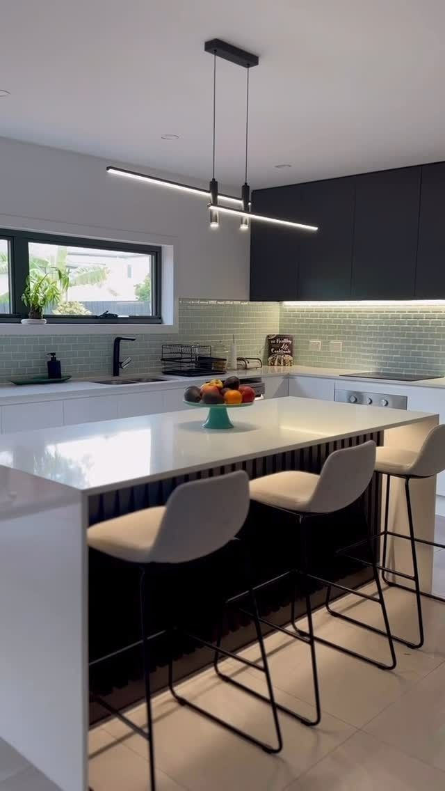 Modern kitchen with island, bar stools, pendant lighting, and fruit bowl. — Zero 21 Fit-Outs & Joinery: Kitchen Renovation Gold Coast in Burleigh Heads, QLD