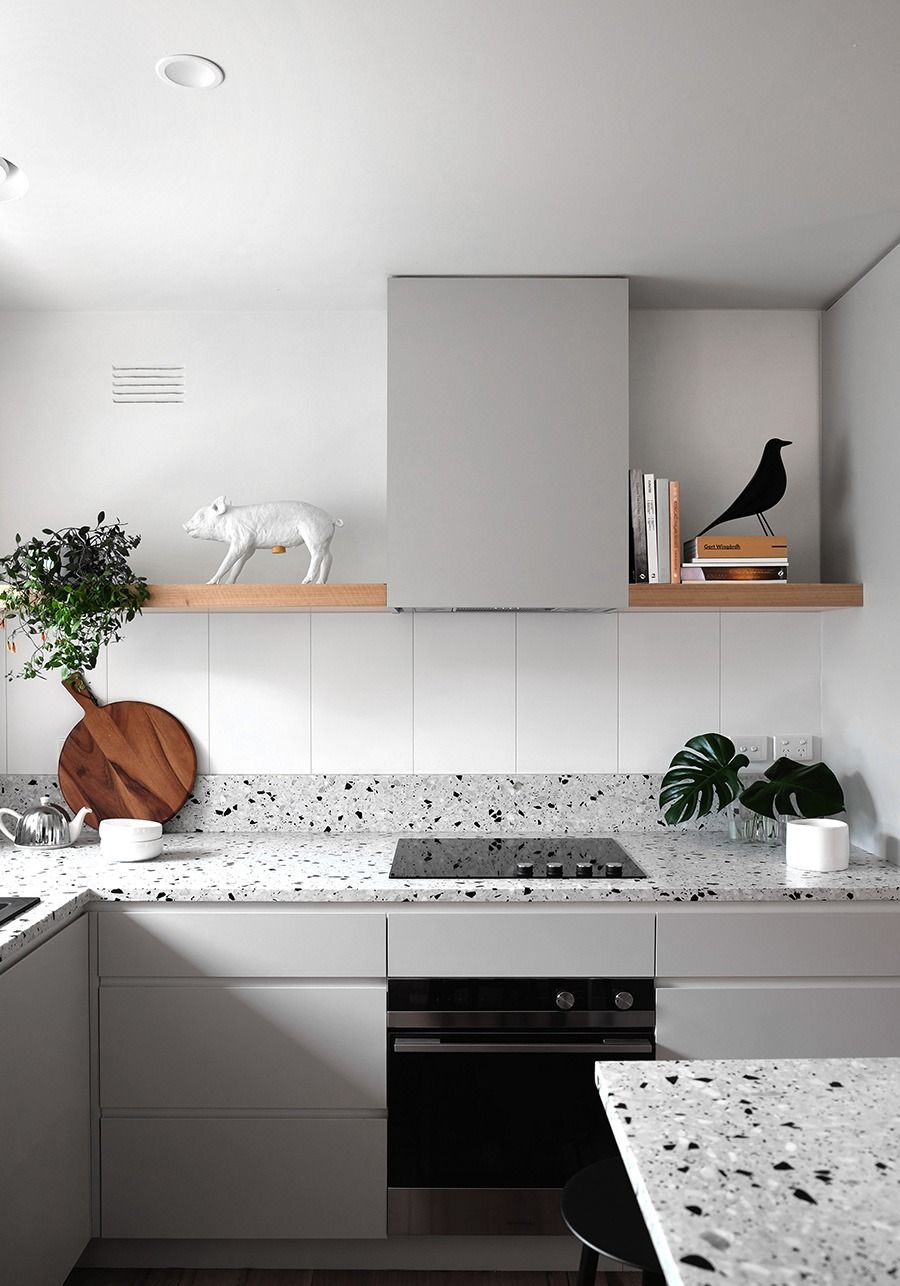 Modern kitchen with terrazzo countertops, gray cabinets, floating shelves, and decorative items. — Zero 21 Fit-Outs & Joinery: Kitchen Renovation Gold Coast in Hope Island, QLD